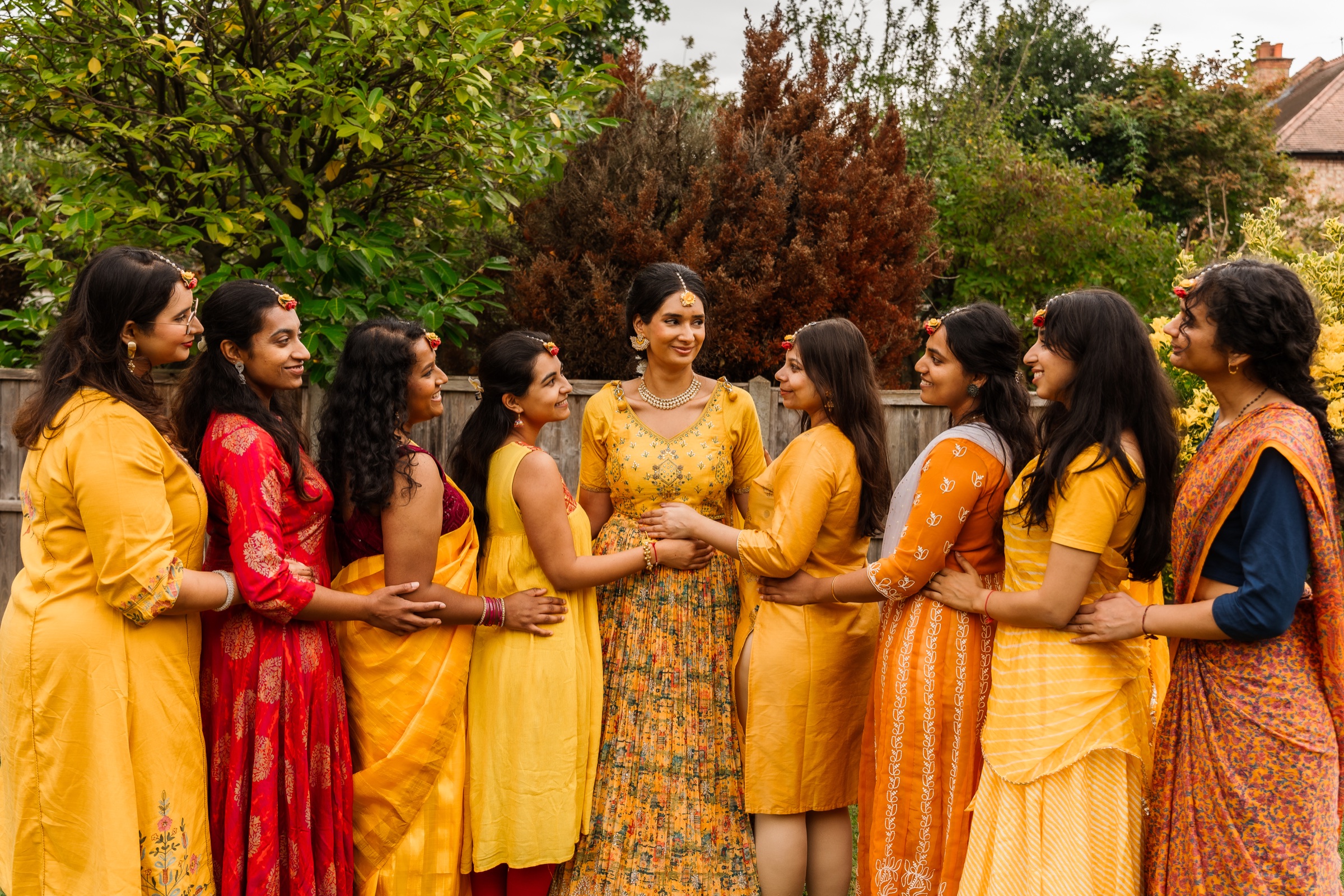 A bride surrounded by family at a pre-wedding celebration