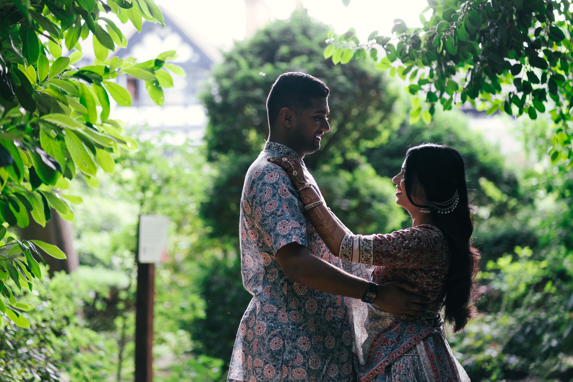 A couple embracing beneath the trees